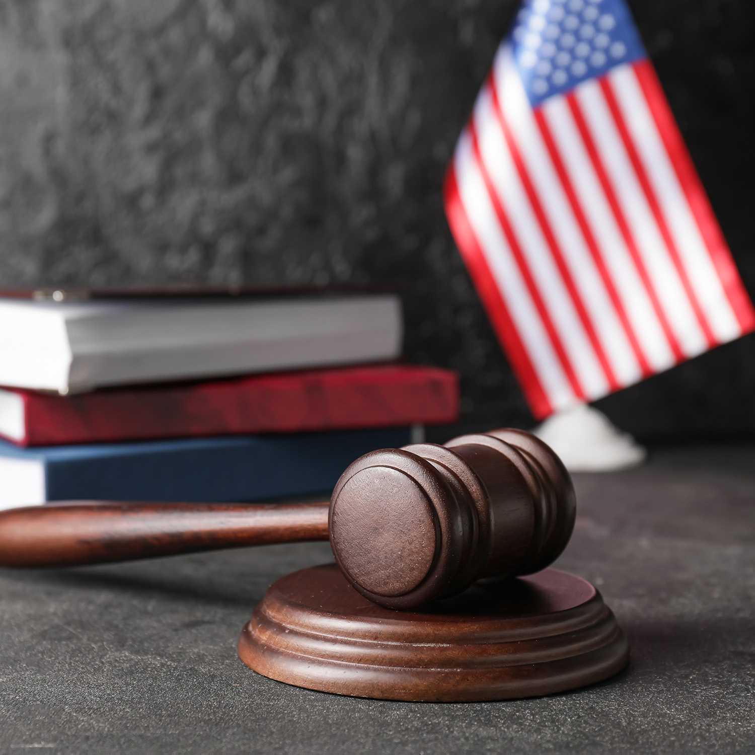 Judge's Gavel With Books And Usa Flag On Dark Background